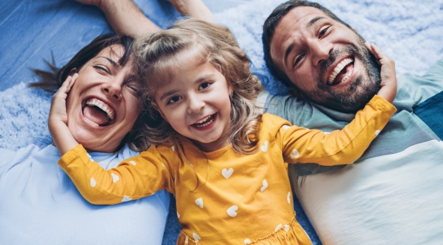 daughter holding the faces of her parents