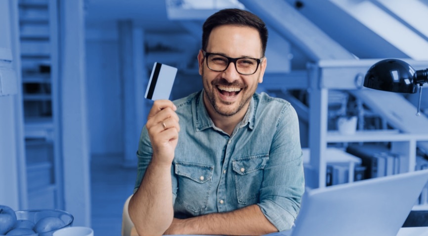 man holding up credit card